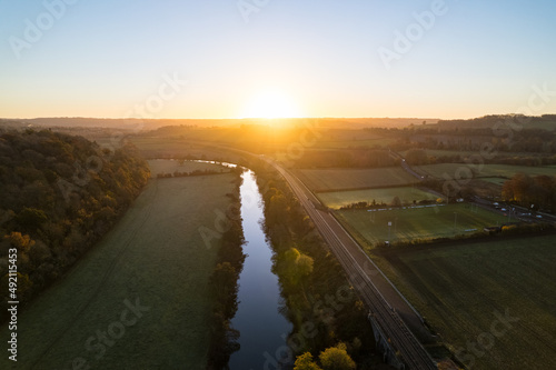 River, railway track, fields and sunset