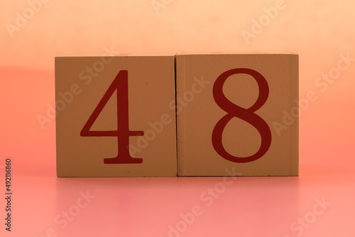 Numbers or dates on wooden cubes, forty-eight photo