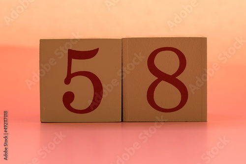 Numbers or dates on wooden cubes, fifty-eight photo