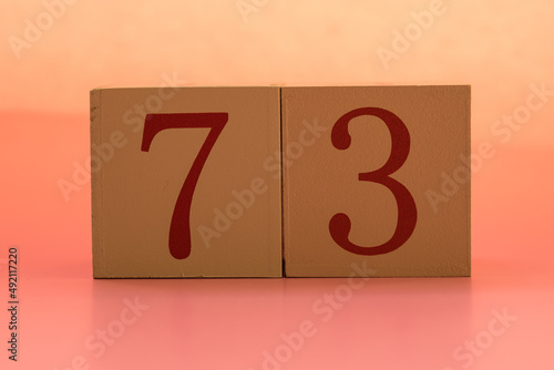 Numbers or dates on wooden cubes, seventy-three photo