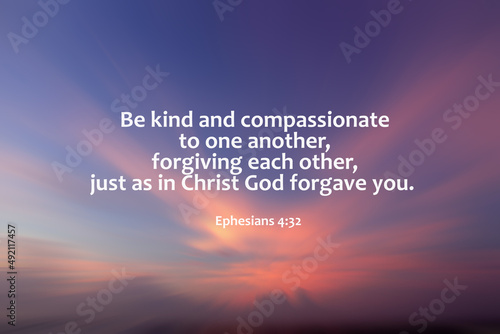 Bible verse quote - Be kind and compassionate to one another, forgiving each other,  just as in Christ God forgive you. Ephesians 4:32 On nature background of blue pink sunset sky with rushing clouds. photo