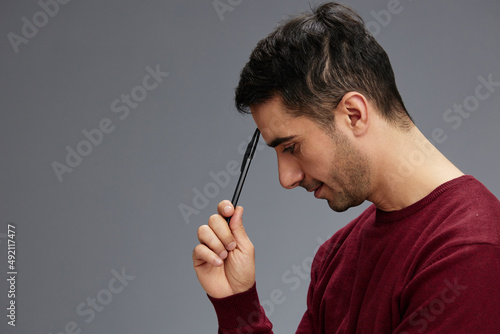 man in a sweater with pen posing emotions business and office concept