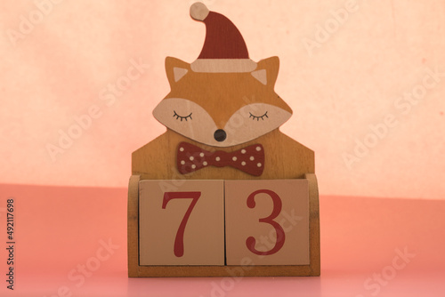 Numbers or dates on wooden cubes with fox, seventy-three photo