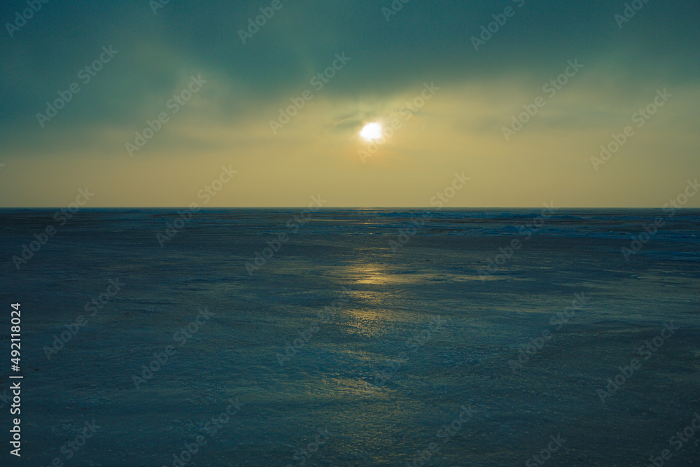 Frozen shore of the Kiev Sea at sunset