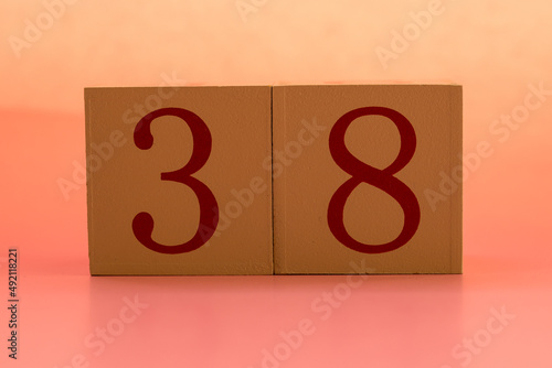 Numbers or dates on wooden cubes, thirty-eight photo