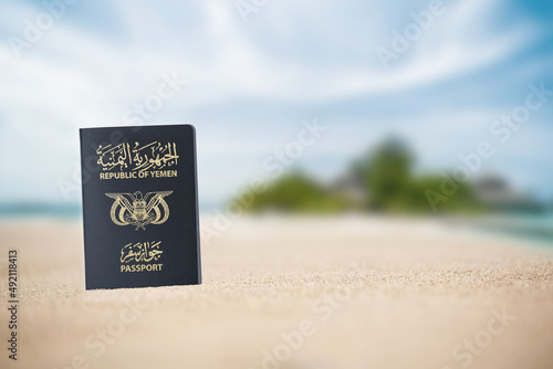 Yemeni passport on the beach sand ,Space for writing ,A Yemeni passport is a government document used by citizens of Yemen for international travel photo