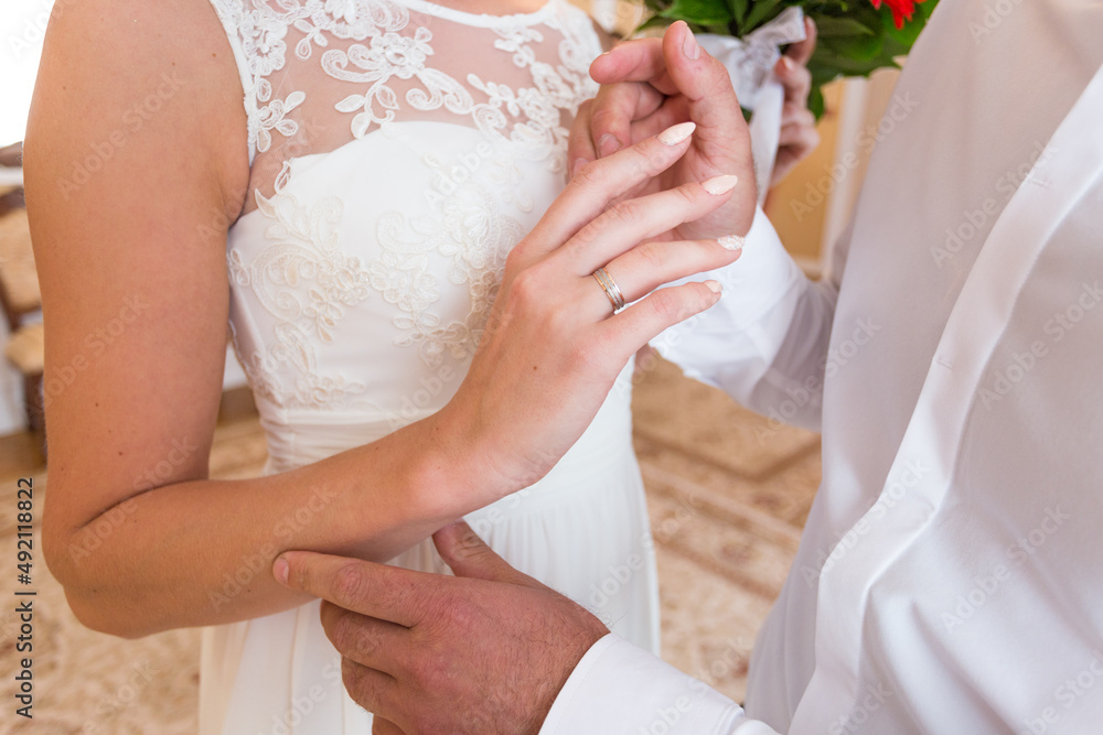 The couple exchanges the wedding rings. just married The couple exchanges the wedding rings. just married