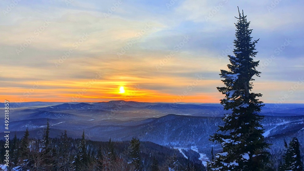 Sunrise in the mountains in winter. Majestic sunset in a winter mountain landscape. Dramatic sky. Sunrise in the mountains in winter. Majestic sunset in a winter mountain landscape. Dramatic sky.