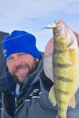 An ice angler with a jumbo perch  photo