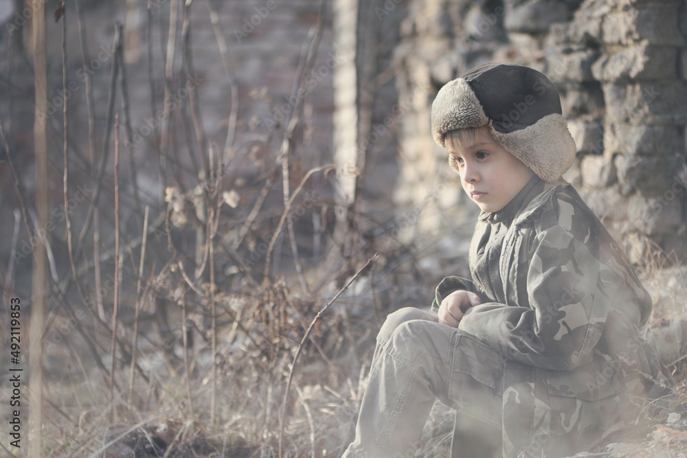 Child and war. Little, poor boy in the ruins of a bombed house. Child and war. Little, poor boy in the ruins of a bombed house.