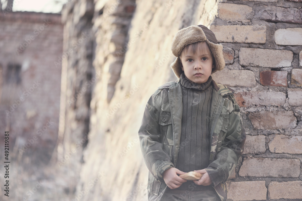 Child and war. Little, poor boy in the ruins of a bombed house. Child and war. Little, poor boy in the ruins of a bombed house.