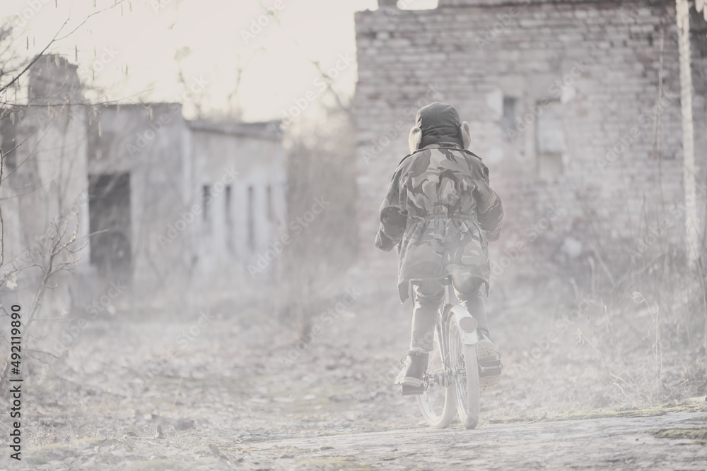 War and the child. Little scared boy in the ruins of the house.
War and the child. Little scared boy in the ruins of the house.