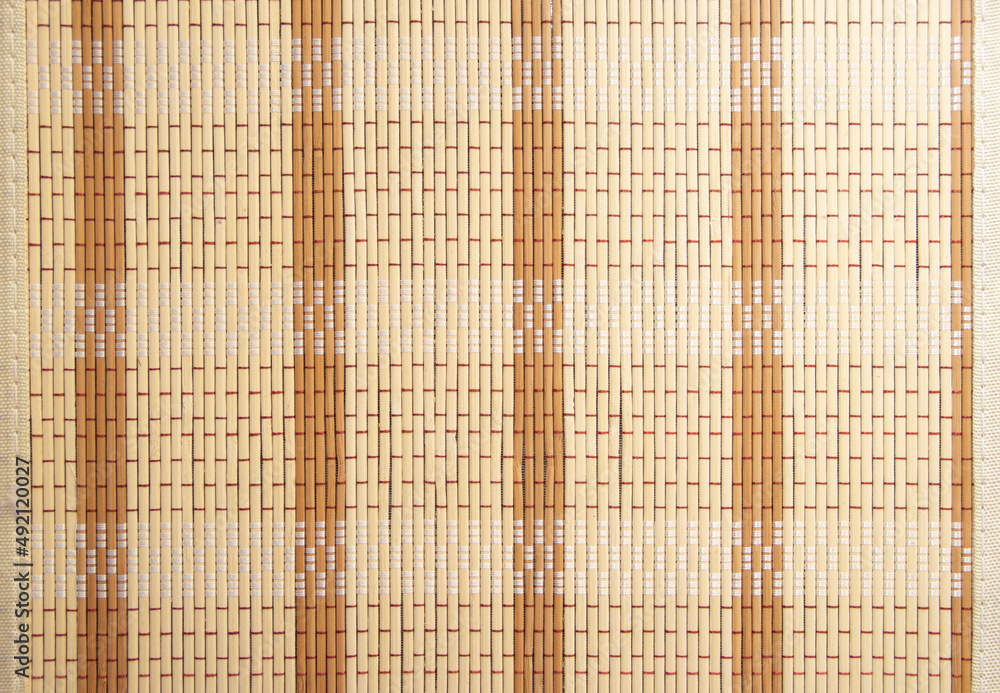 Background of a bamboo napkin roll. Bamboo napkin. Straw background Background of a bamboo napkin roll. Bamboo napkin. Straw background