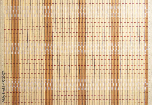 Background of a bamboo napkin roll. Bamboo napkin. Straw background