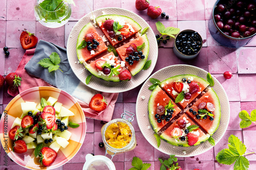 Fresh summer salad with berries and fruits on watermelon with feta cheese