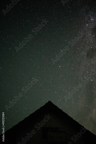 starry sky and the roof of a house