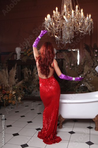 Beautiful woman in red dress, Jessica Rabbit cosplay. dancing with a glass of champagne