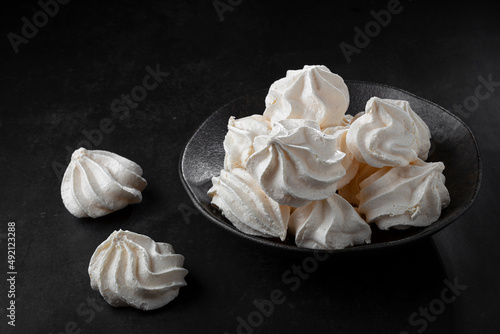 Quadro em tela Delicious meringue cookies on the table.