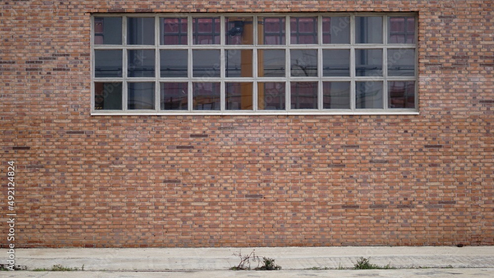 sidewalk with brick industrial facade