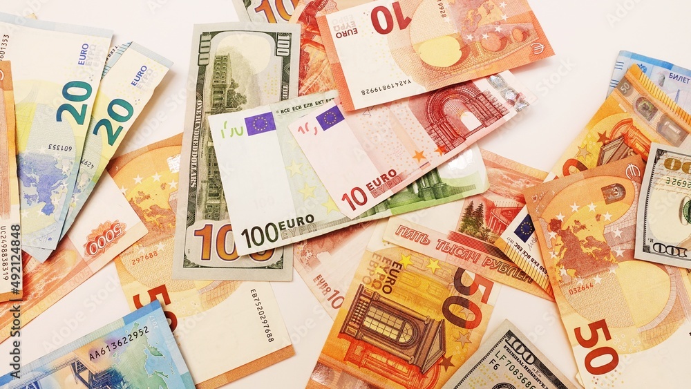 Top view of bundles of money in various currencies. Dollars, euros and rubles. The global economic crisis. Financial literacy. Currency basket Top view of bundles of money in various currencies. Dollars, euros and rubles. The global economic crisis. Financial literacy. Currency basket