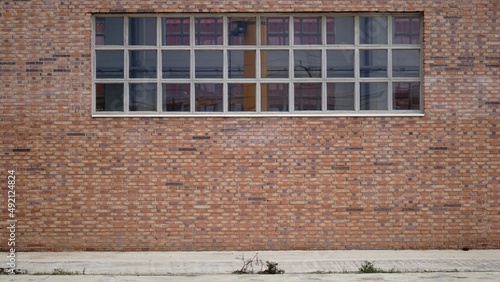 sidewalk with brick industrial facade