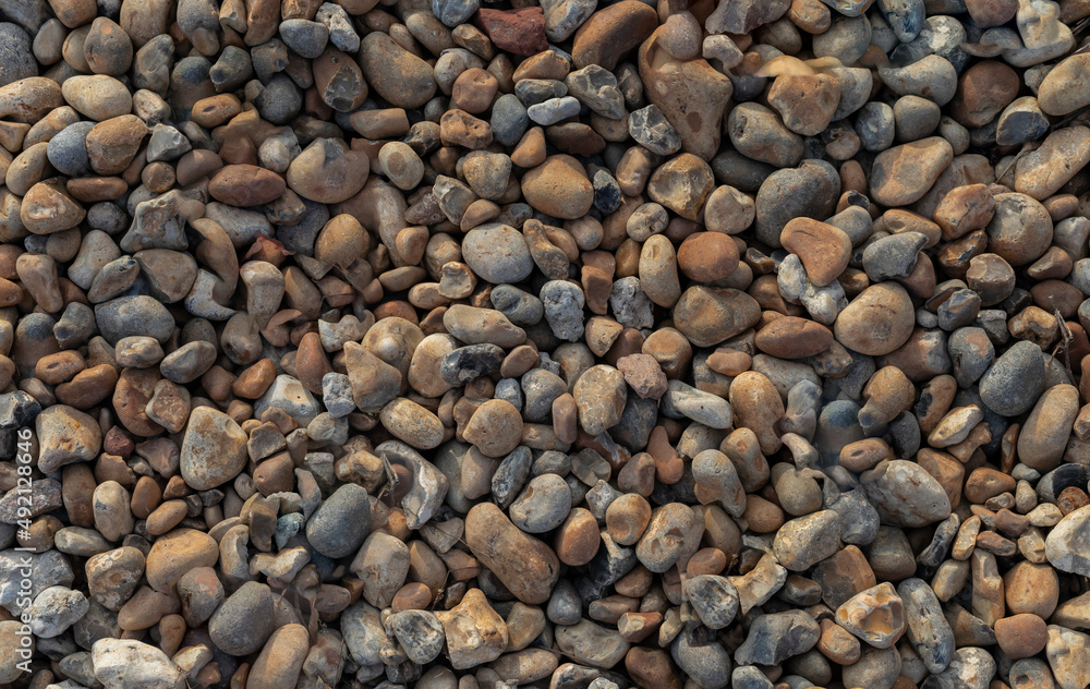 Background of mixed pebbles which are orange blue and grey Background of mixed pebbles which are orange blue and grey