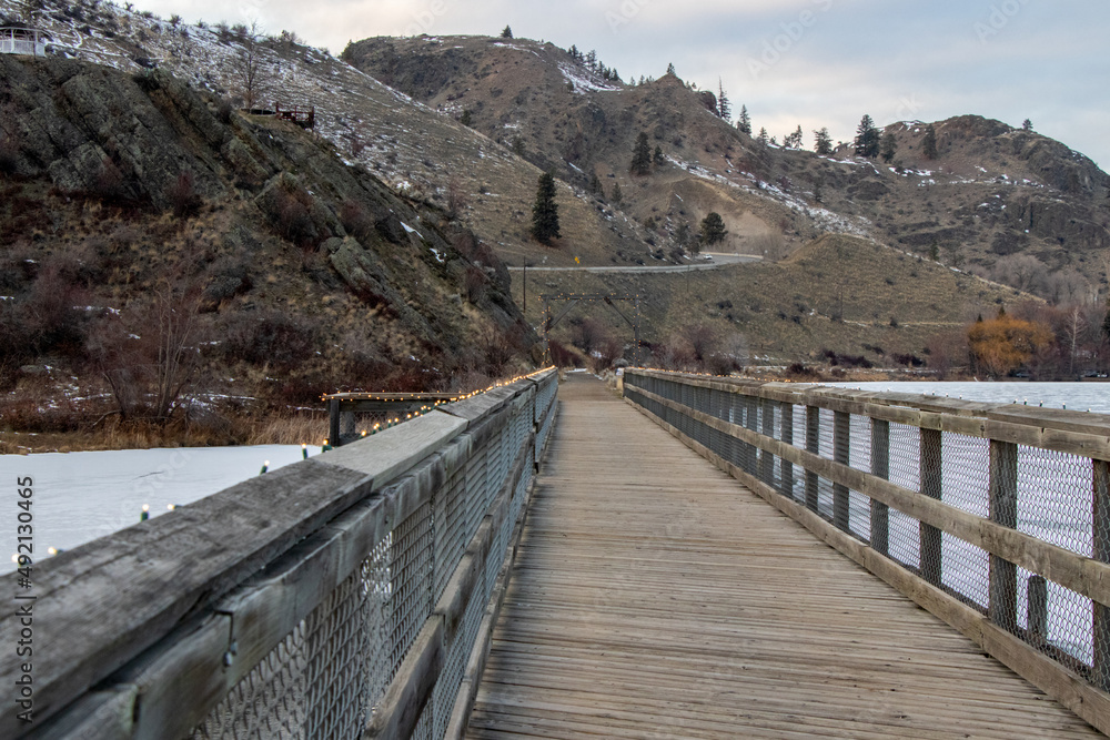 boardwalk over a frozen lake in the mountains in Okanagan Falls, British Columbia, Canada on a cold winter day