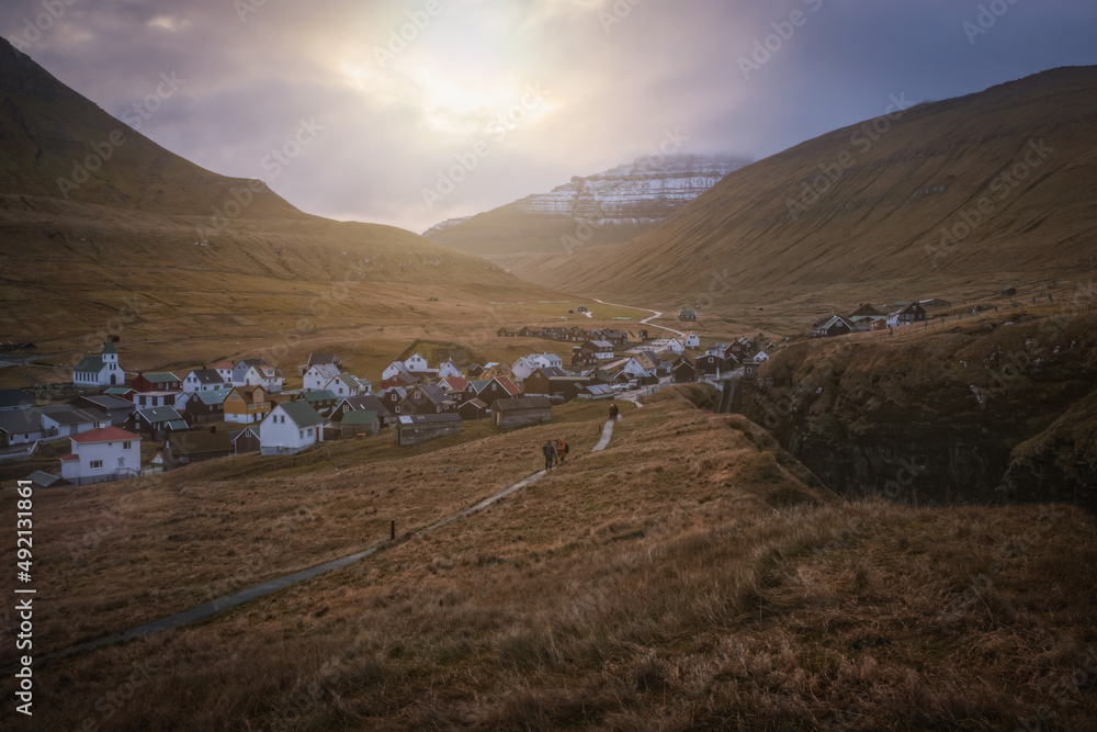 Gjogv village on the island of Eysturoy, Faroe Islands. Scandinavian colored houses. November 2021, sunset time.