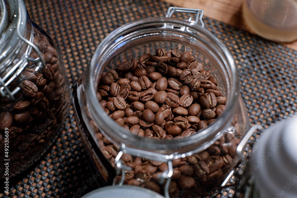 Fototapeta premium coffee in glass jar at barista table. top view
