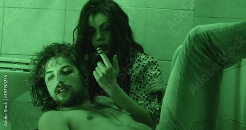 drug, high - stoned junkie couple lying on the floor in the bathroom photo