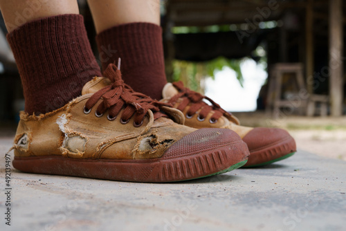 фотографія Torn student shoes, Poverty of rural schoolchildren often cannot afford new shoe
