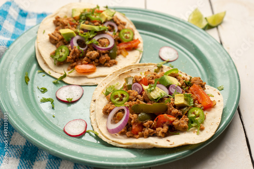 Ground beef tacos with avocado and bell peppers. Mexican food