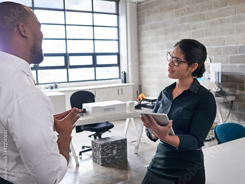 Collaborating on a new project. Shot of colleagues having a discussion at the office.