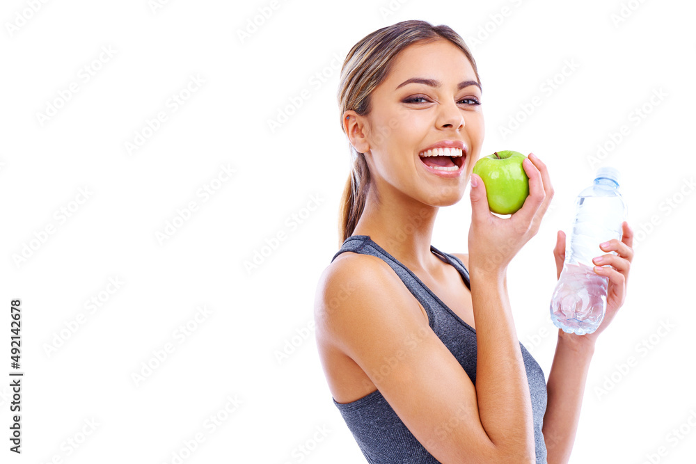 Her secrets to vitality. Portrait of a sporty young woman holding an apple and a bottle of water against a white background. Her secrets to vitality. Portrait of a sporty young woman holding an apple and a bottle of water against a white background.