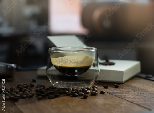 Glass of black coffee put on wooden desk,