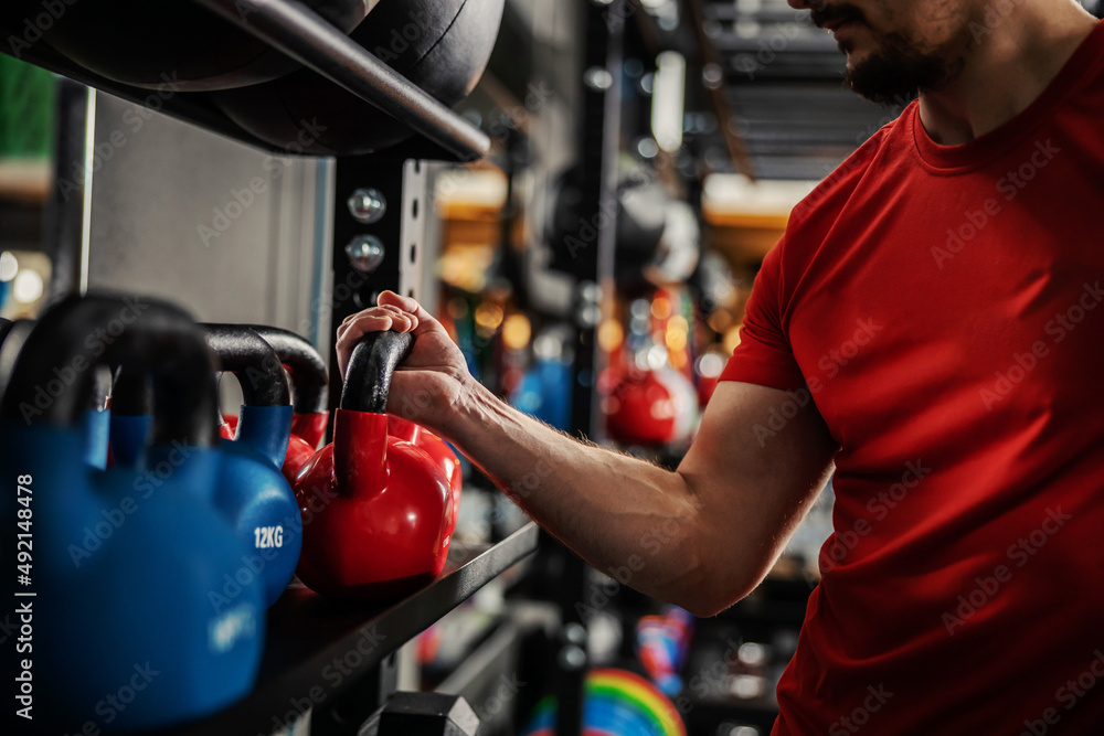 Gripping kettle bell in focus. 