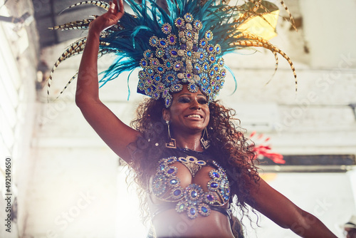 Her beauty enchants all. Shot of a samba dancer performing in a carnival. photo
