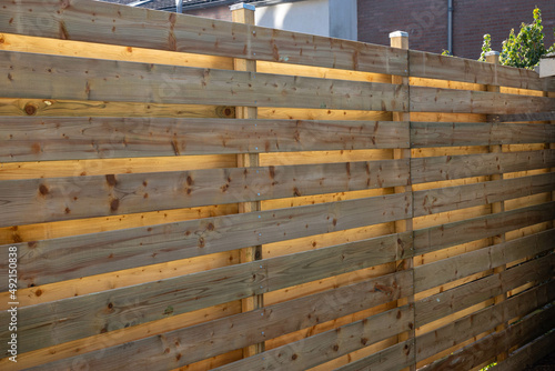 New wooden build fence in a garden in Hoofddorp The Netherlands after storm damage taken by storm Corrie, Eunice, Dudley and Franklin.  photo