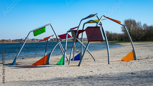 beautiful diverse colored playground equipment on a beach in a park called  toolenburgse plas in Hoofddorp The Netherlands photo