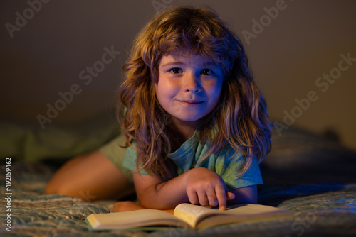 Child reading book. Dreaming child read bedtime stories, fairystory or fairytale. photo