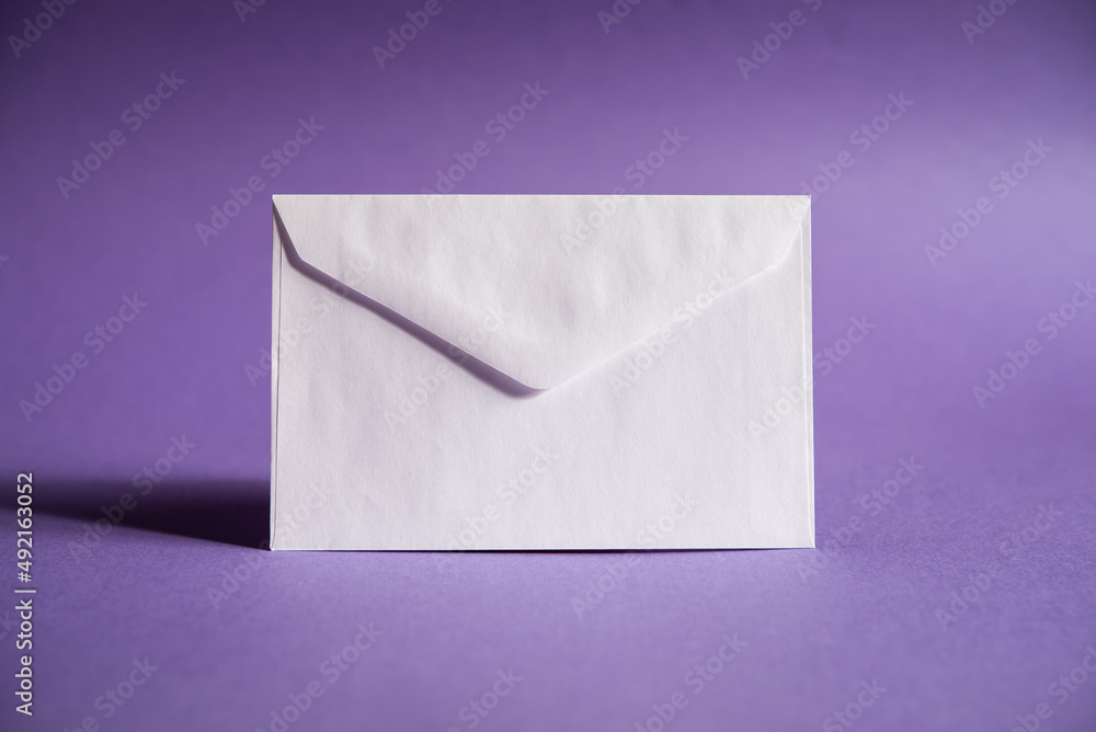 a white envelope on a purple background, send a message, or a news item. a white envelope on a purple background, send a message, or a news item.