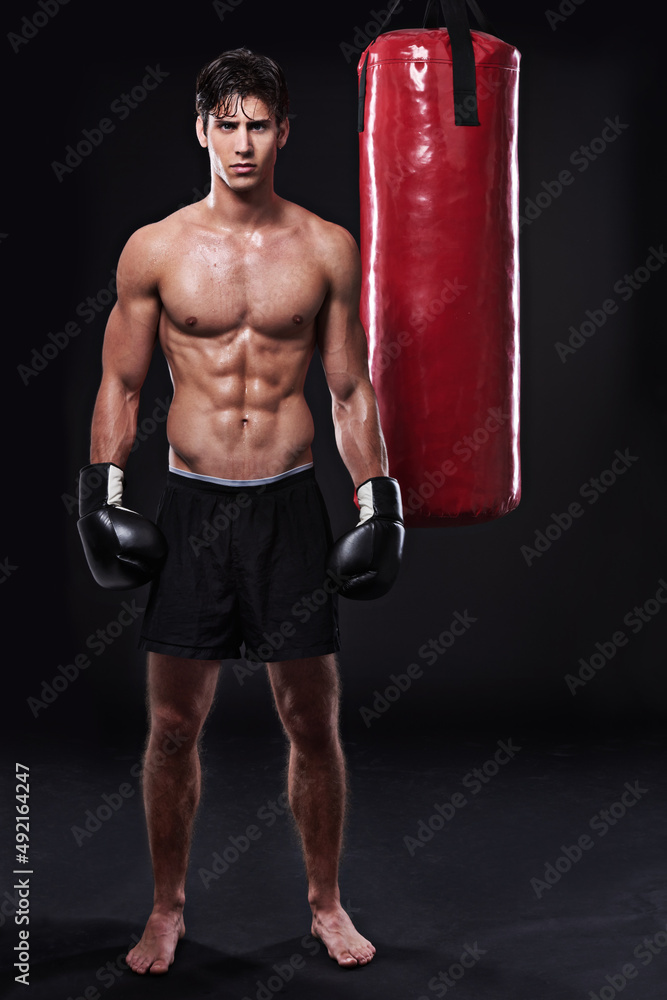 Lean mean fighting machine. Studio shot of a young mixed martial artist.