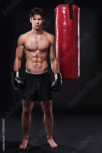 Lean mean fighting machine. Studio shot of a young mixed martial artist.