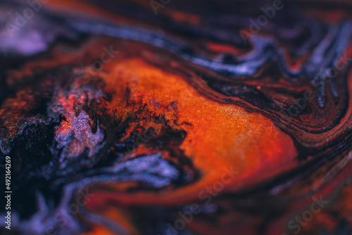 Ink background. Abstract colorful design. Creative paint mixture. Purple violet orange colors blend