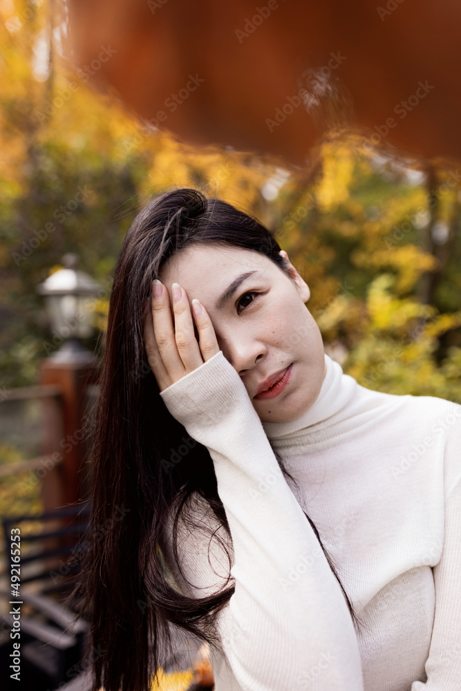 Sad tired Asian woman lonely at outdoor cafe during self isolation quarantine for COVID-19 Coronavirus social distancing prevention. Mental health, anxiety depressed thinking lady. Sad tired Asian woman lonely at outdoor cafe during self isolation quarantine for COVID-19 Coronavirus social distancing prevention. Mental health, anxiety depressed thinking lady.
