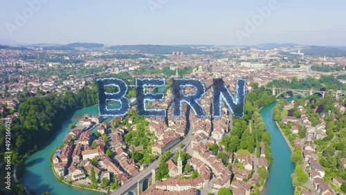 Inscription on video. Bern, Switzerland. Historic city center, general view, Aare river. Blue lights form luminous. Electric style, Aerial View