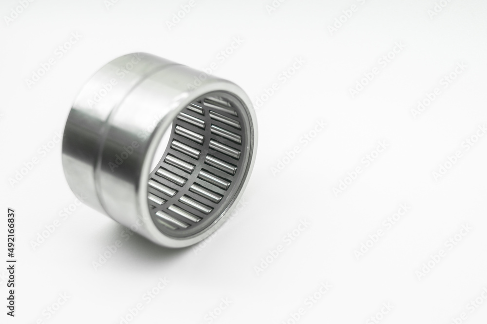 Needle bearing on a white background. Roller bearing for motors, machinery and equipment. Spare part. Selective focus, isolated on white Needle bearing on a white background. Roller bearing for motors, machinery and equipment. Spare part. Selective focus, isolated on white