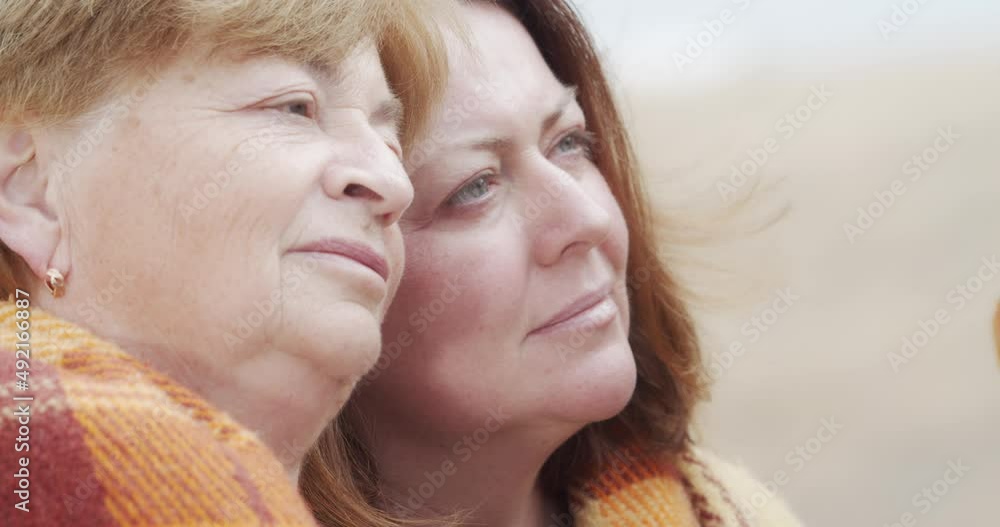 Mother and daughter covered themselves with a blanket and hug. Close-up portrait. Mother and daughter covered themselves with a blanket and hug. Close-up portrait.