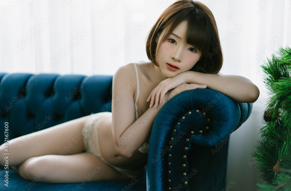 Pretty sexy Asian woman in white lace bra lingerie underwear sexually lying  on sofa and looking at camera. Sexy japanese girl lifestyle concept. Stock  Photo | Adobe Stock