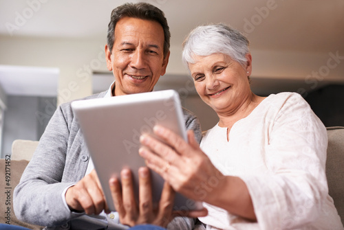 Getting to know the world of technology. A senior couple using a digital at home.